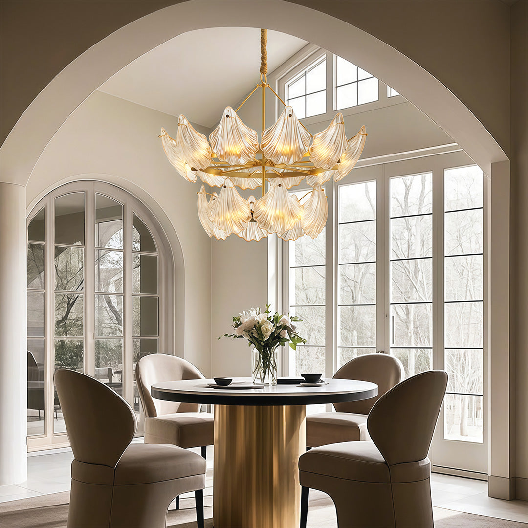 Modern luxury chandeliers enhancing architectural dining room with arched windows and round table
