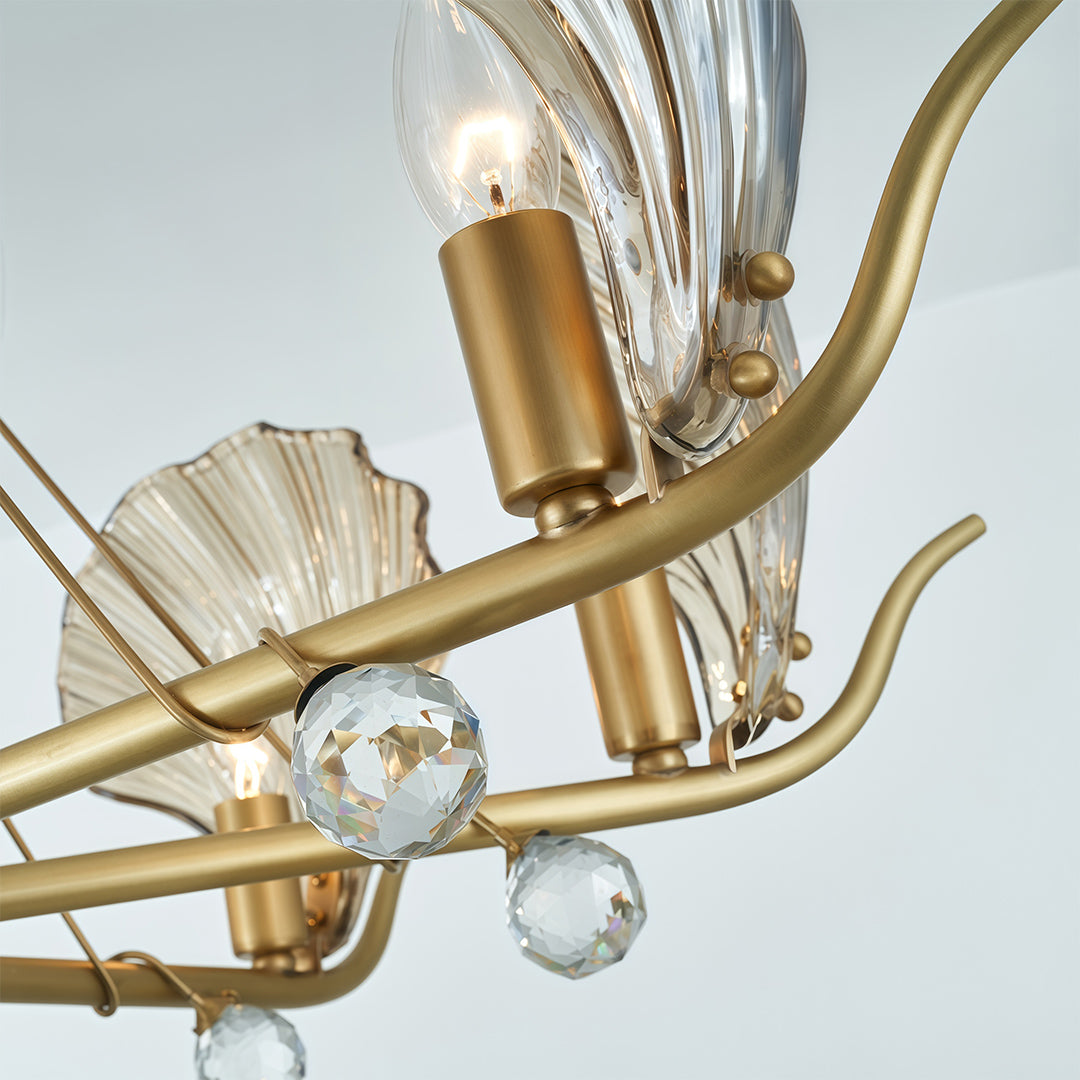 Modern large chandeliers close-up detail showcasing brass arms and textured glass leaf craftsmanship