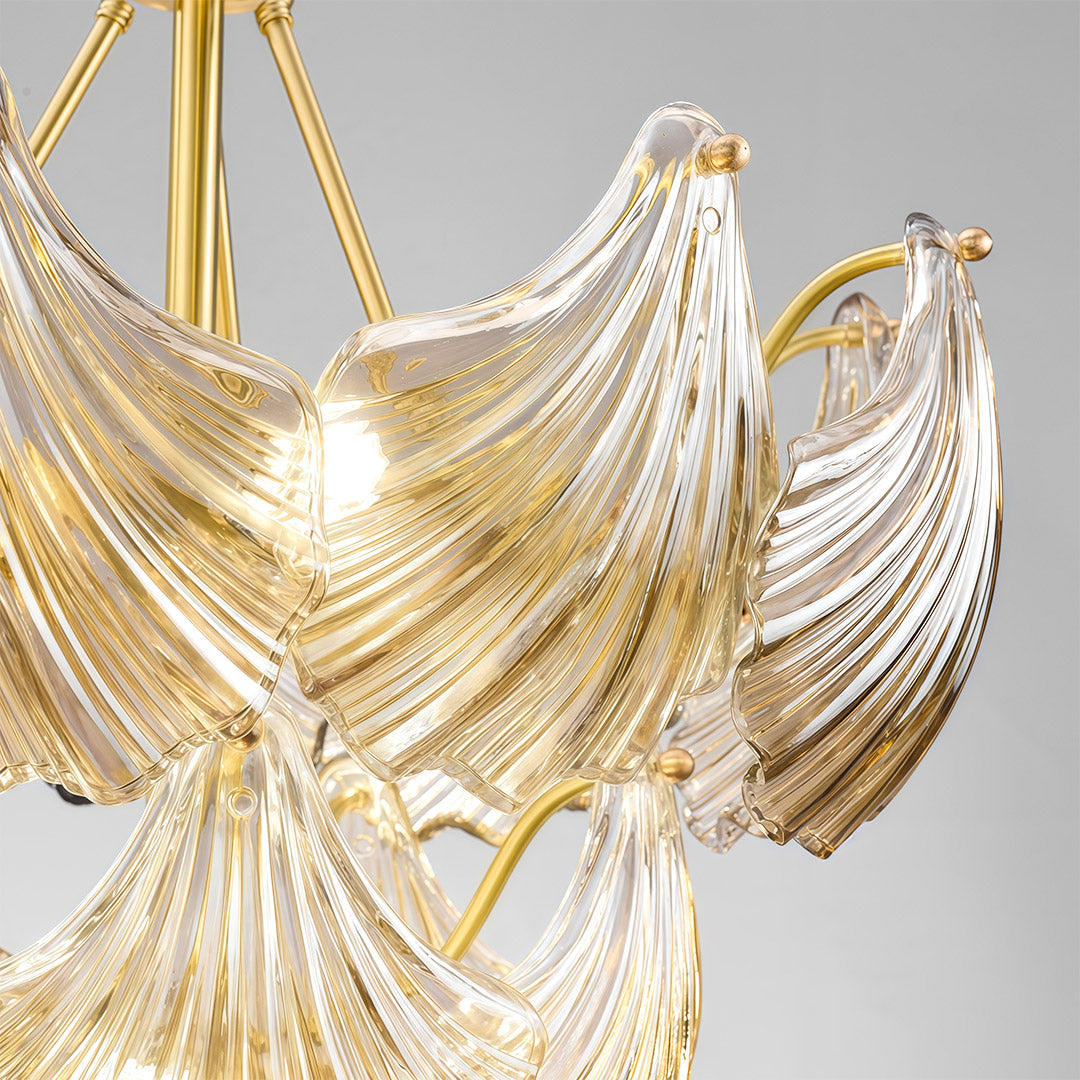 Modern luxury chandeliers close-up detail showcasing brass framework and glass leaf texture