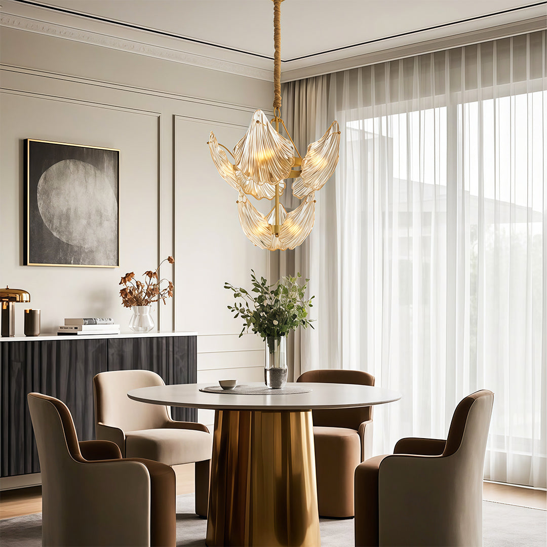 Modern luxury chandeliers illuminating sophisticated living room with brass table and white seating