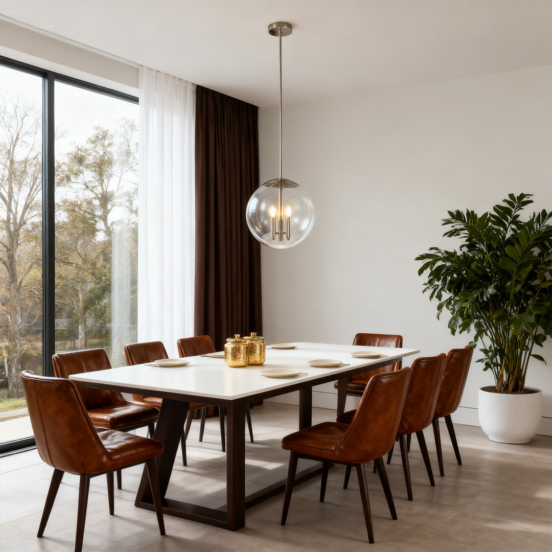 Modern dining room with a glass orb pendant light illuminating a long rectangular table and leather chairs in front of large windows.