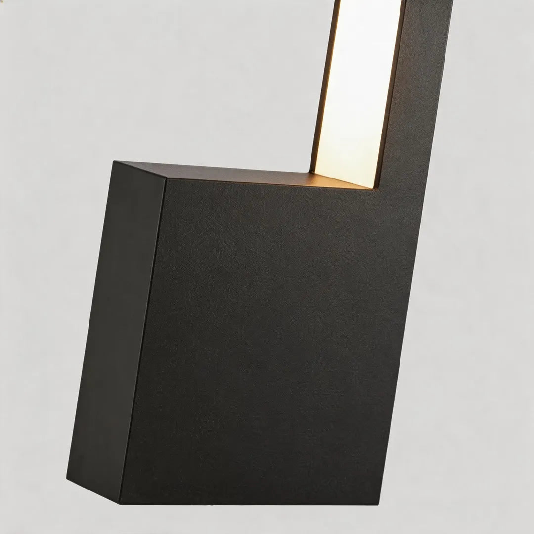 Modern LED bollard light with textured black metal base and warm light detail
