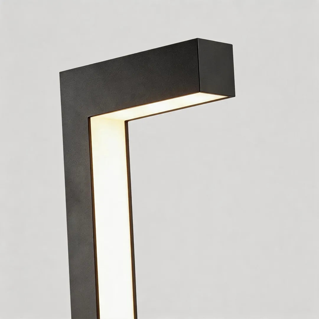 Modern LED bollard light with black L shaped frame and warm integrated lighting