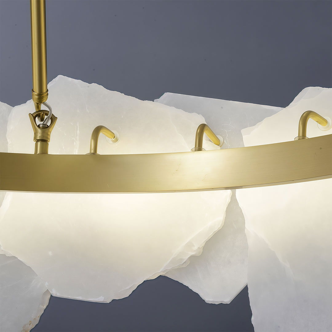 Modern LED chandelier above contemporary dining table in neutral interior with textured walls.