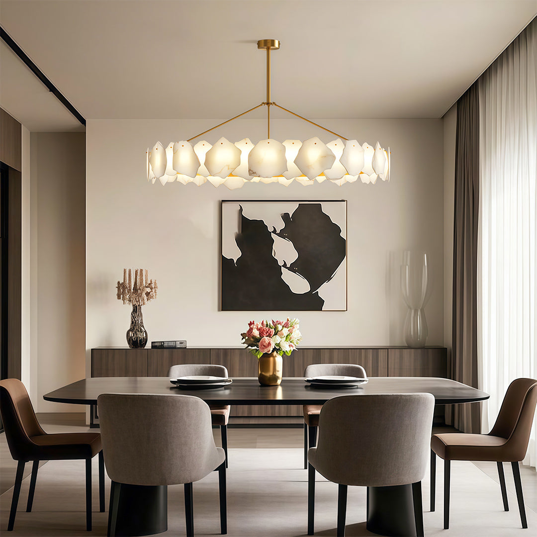 Luxury modern LED chandelier illuminating luxurious dining area with marble table and plush seating.