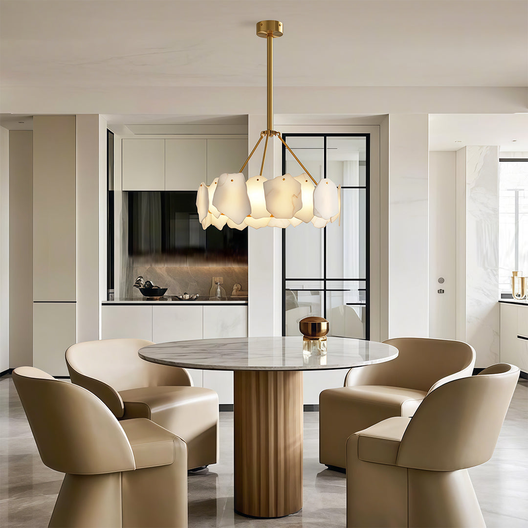 Luxury modern LED chandelier above round dining table in warm modern interior with wood tones.
