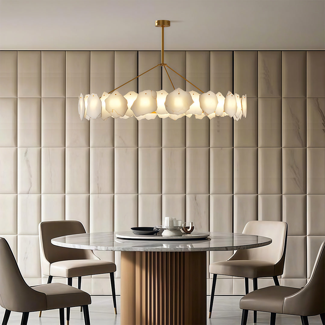 Modern LED chandelier illuminating sophisticated dining space with grey upholstered chairs.
