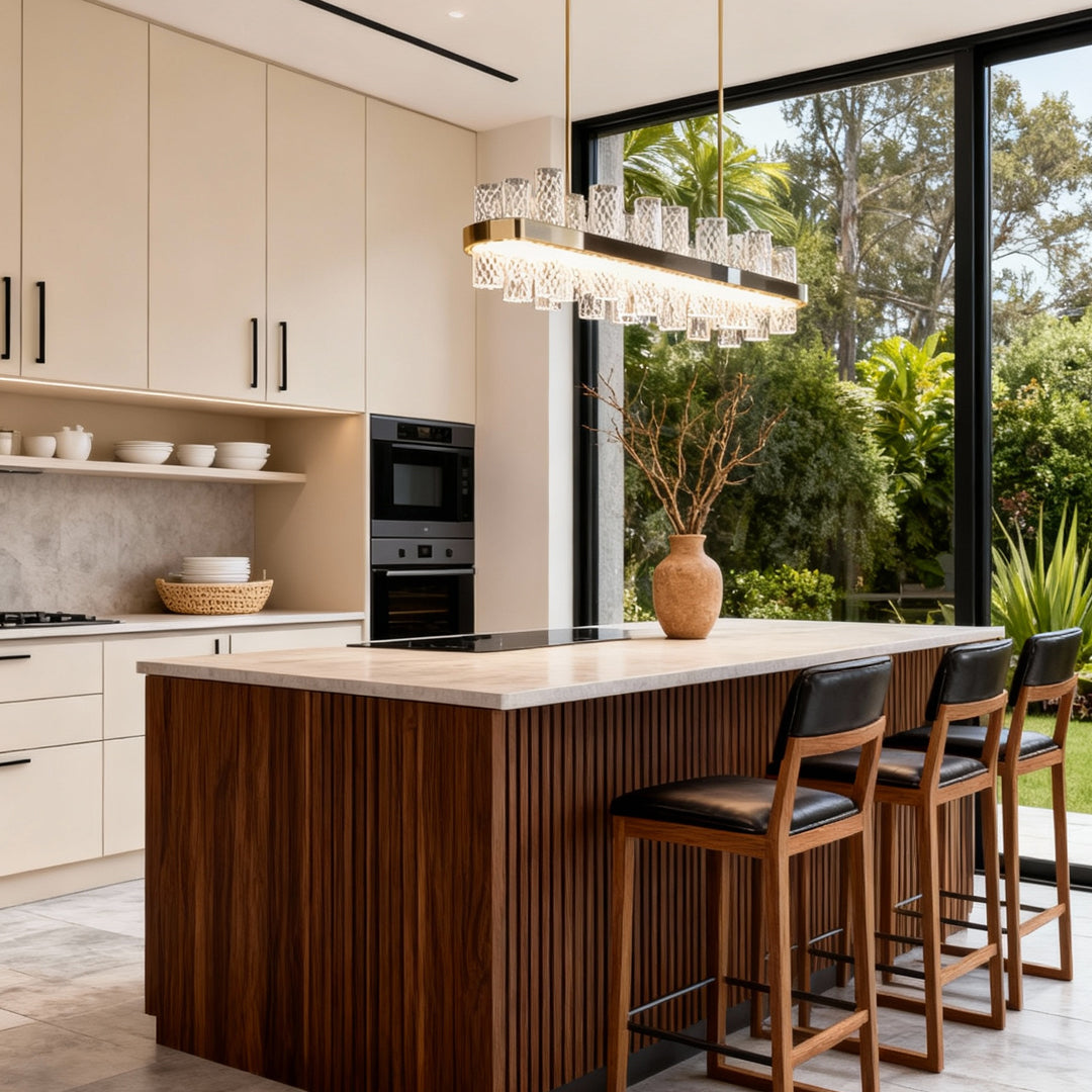 Modern led lighting chandelier illuminating open-plan kitchen with island and outdoor views through floor-to-ceiling windows