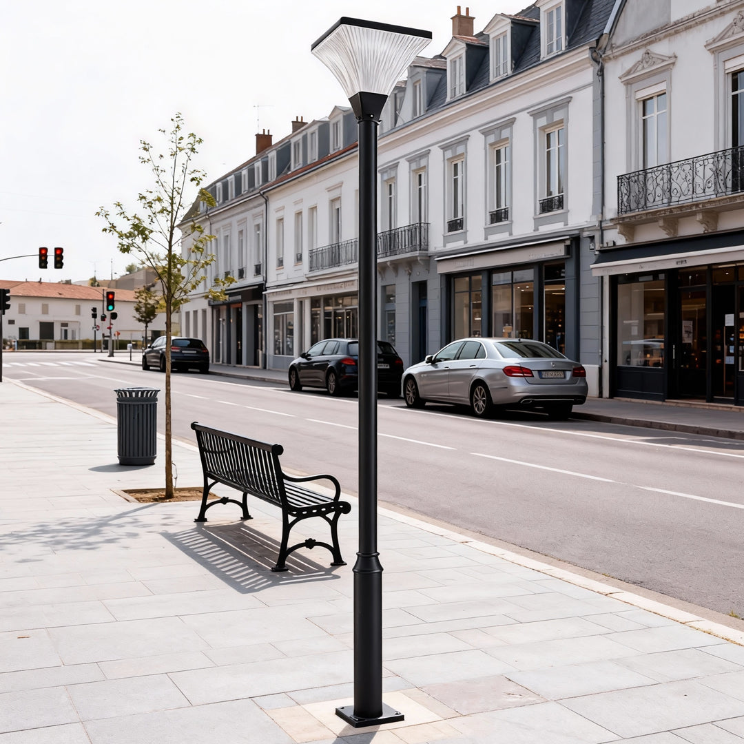 Modern LED night street light illuminating a quiet urban sidewalk with classic European buildings.