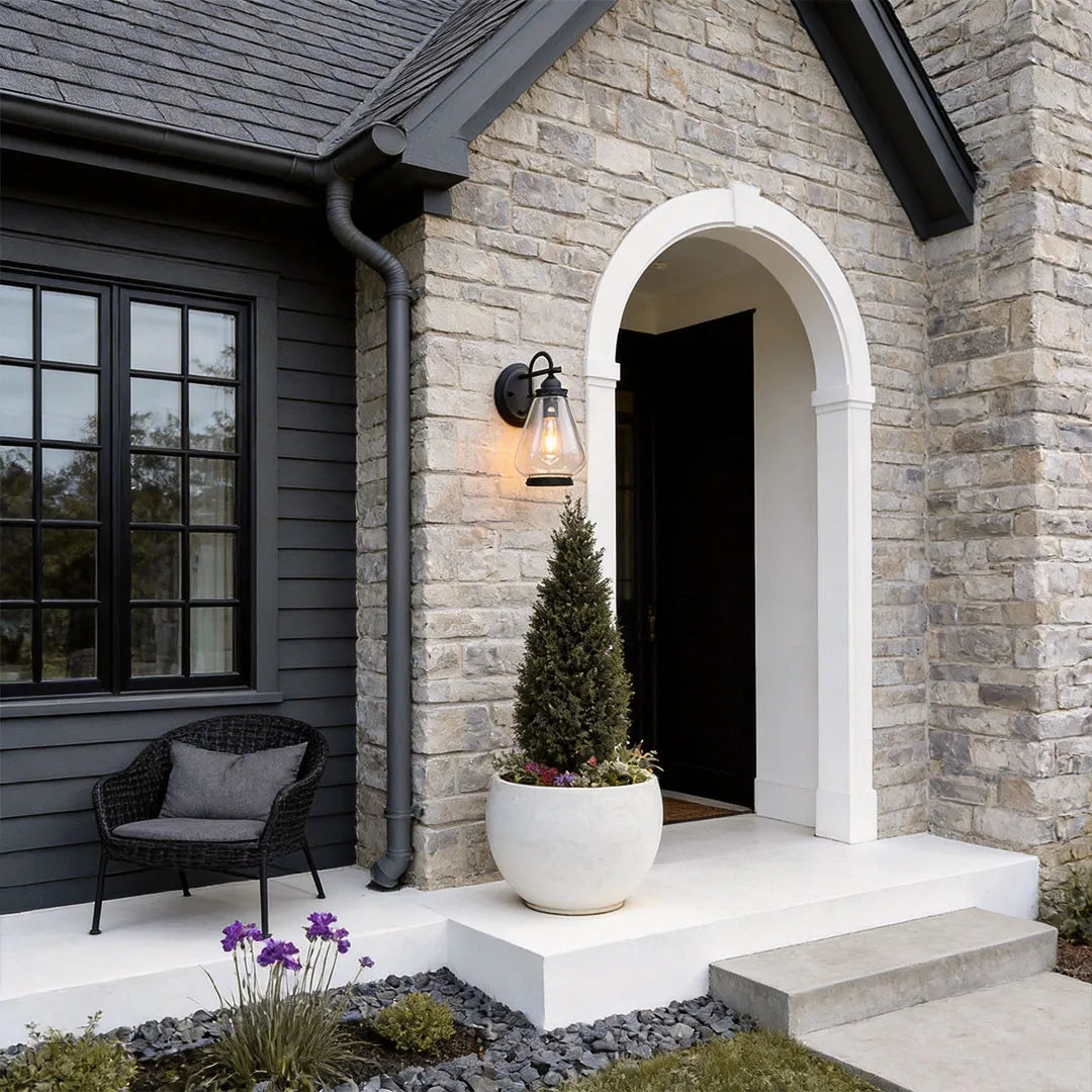 Modern LED outdoor wall light providing warm entry lighting on a minimalist contemporary home.