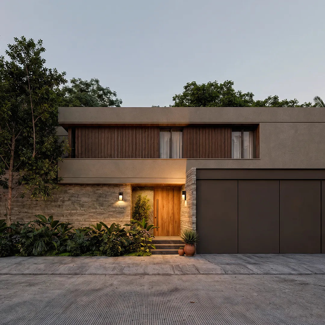 Modern LED outdoor wall light providing warm entry lighting on a minimalist modern house exterior.