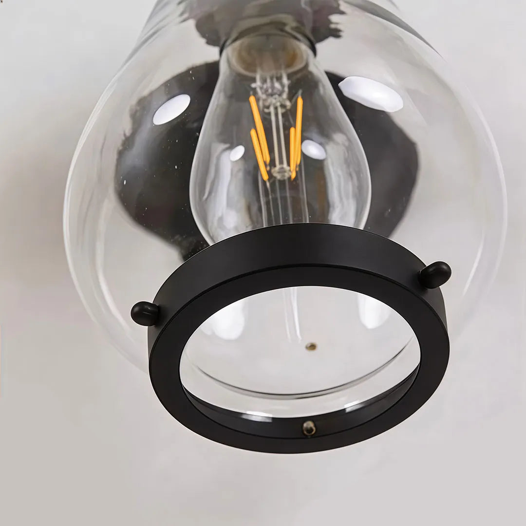 Modern LED outdoor wall light close-up showing the black cylindrical housing and reflective LED optic.