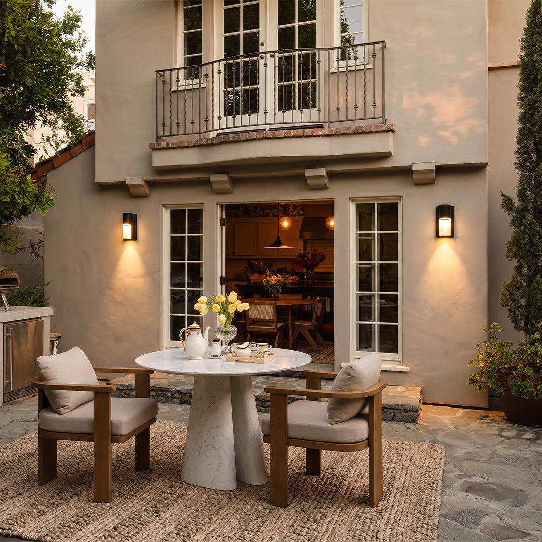 Modern LED outdoor wall light pair illuminating an outdoor dining area on a contemporary home.