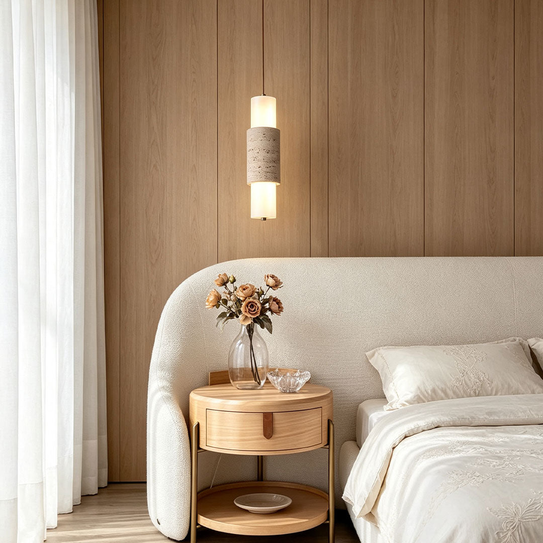 Modern LED pendant lights hanging beside a bedroom seating area with soft decorative illumination.