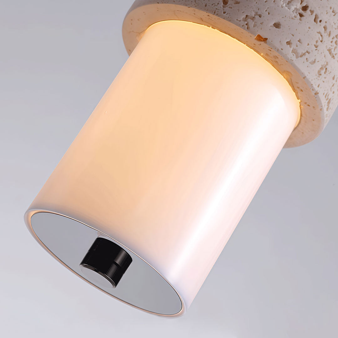 Close-up of modern LED pendant lights showing the glowing cylindrical diffuser and metal trim.