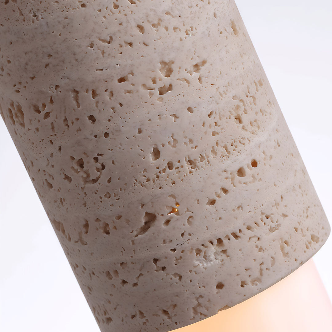 Close-up of modern LED pendant lights highlighting the natural stone texture and warm integrated glow.