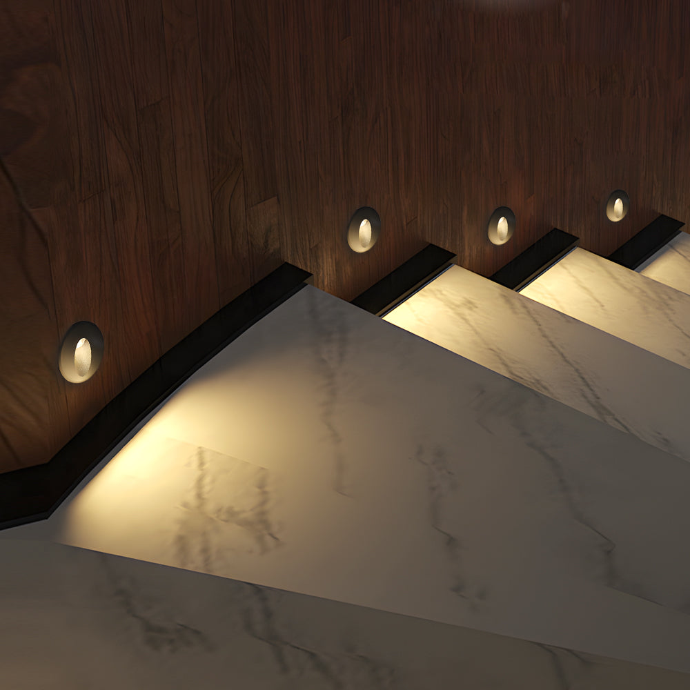 Modern LED step light creating warm directional illumination on concrete stairs for safe nighttime navigation and architectural accent