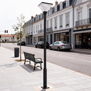 Modern LED street light illuminating a quiet urban sidewalk with classic European buildings.