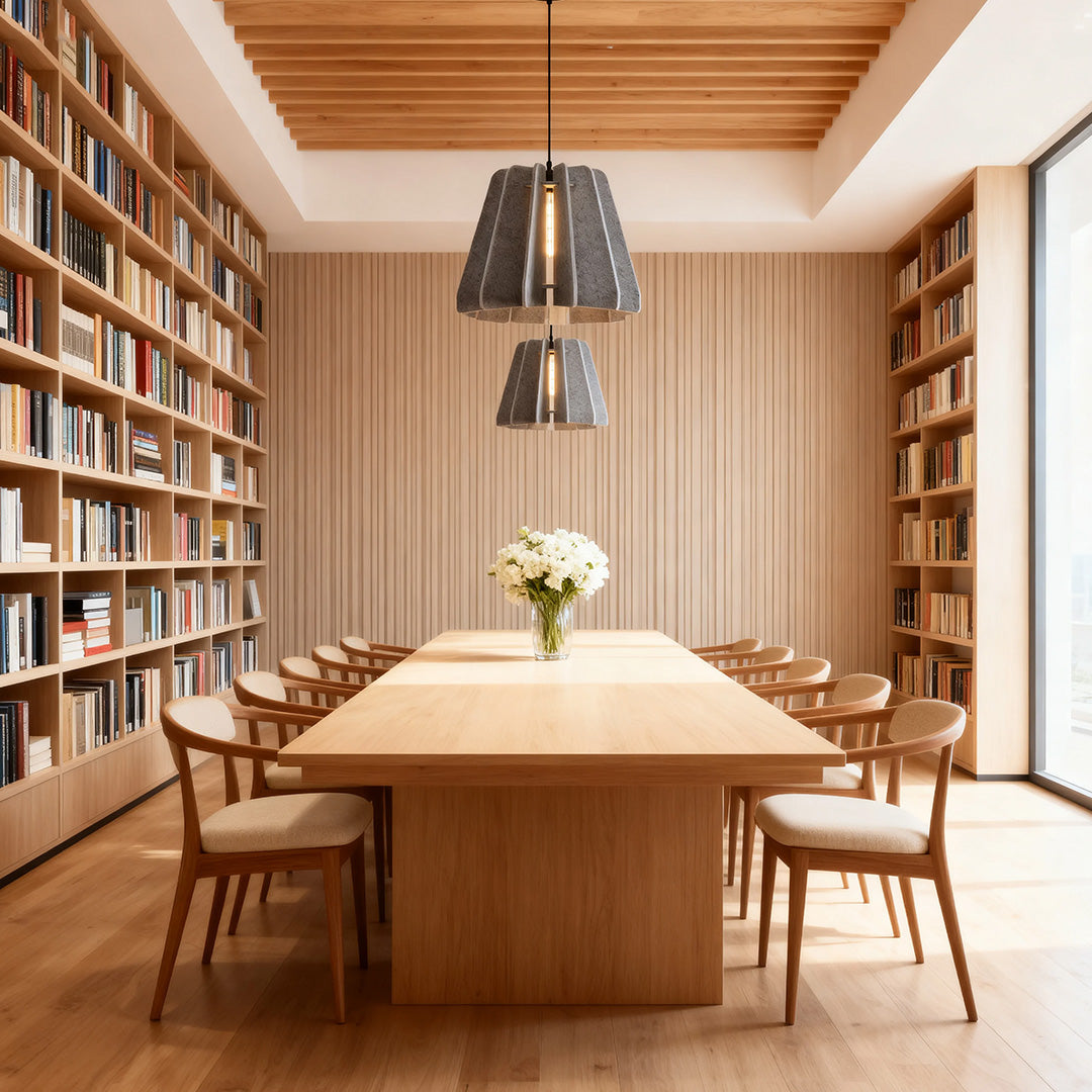 1 light single pendant in a modern library dining room, featuring a long wooden table and full-height bookshelves.