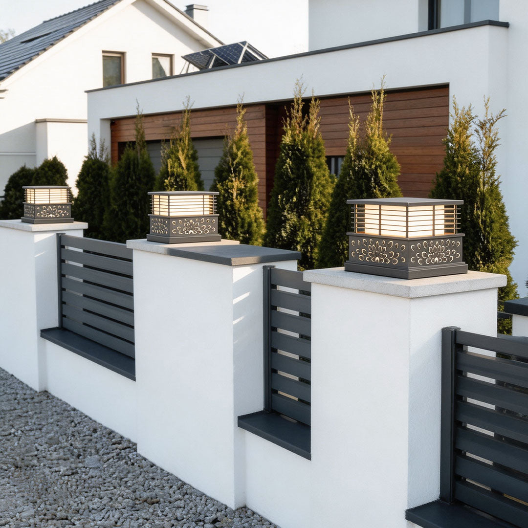 Modern light pillar for home with a sleek design, installed on a white fence beside a contemporary house.