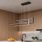 Modern linear LED chandelier illuminating a contemporary kitchen island with sleek, ambient glow.