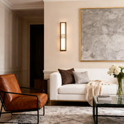 Modern linear wall lighting installed above a sofa, providing soft ambient light for a cozy living room setting.