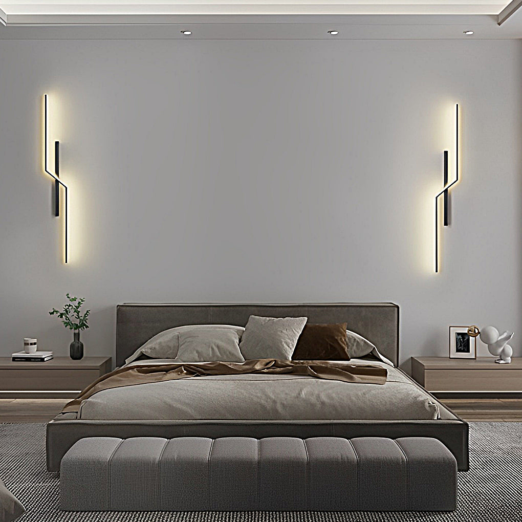 Pair of modern linear wall sconce fixtures mounted beside bed for minimalist bedroom lighting.