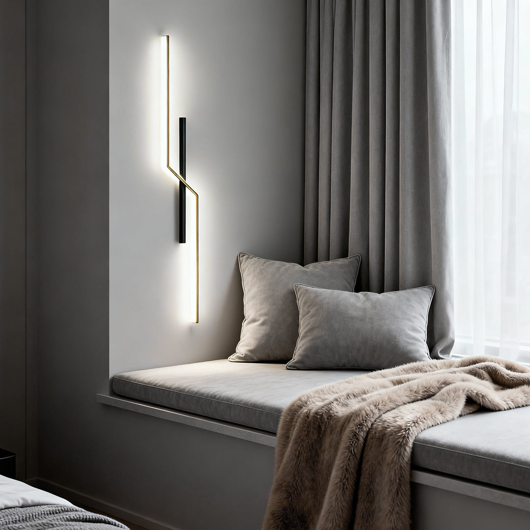 Slim modern linear wall sconce used as vertical decorative lighting beside window in modern bedroom.