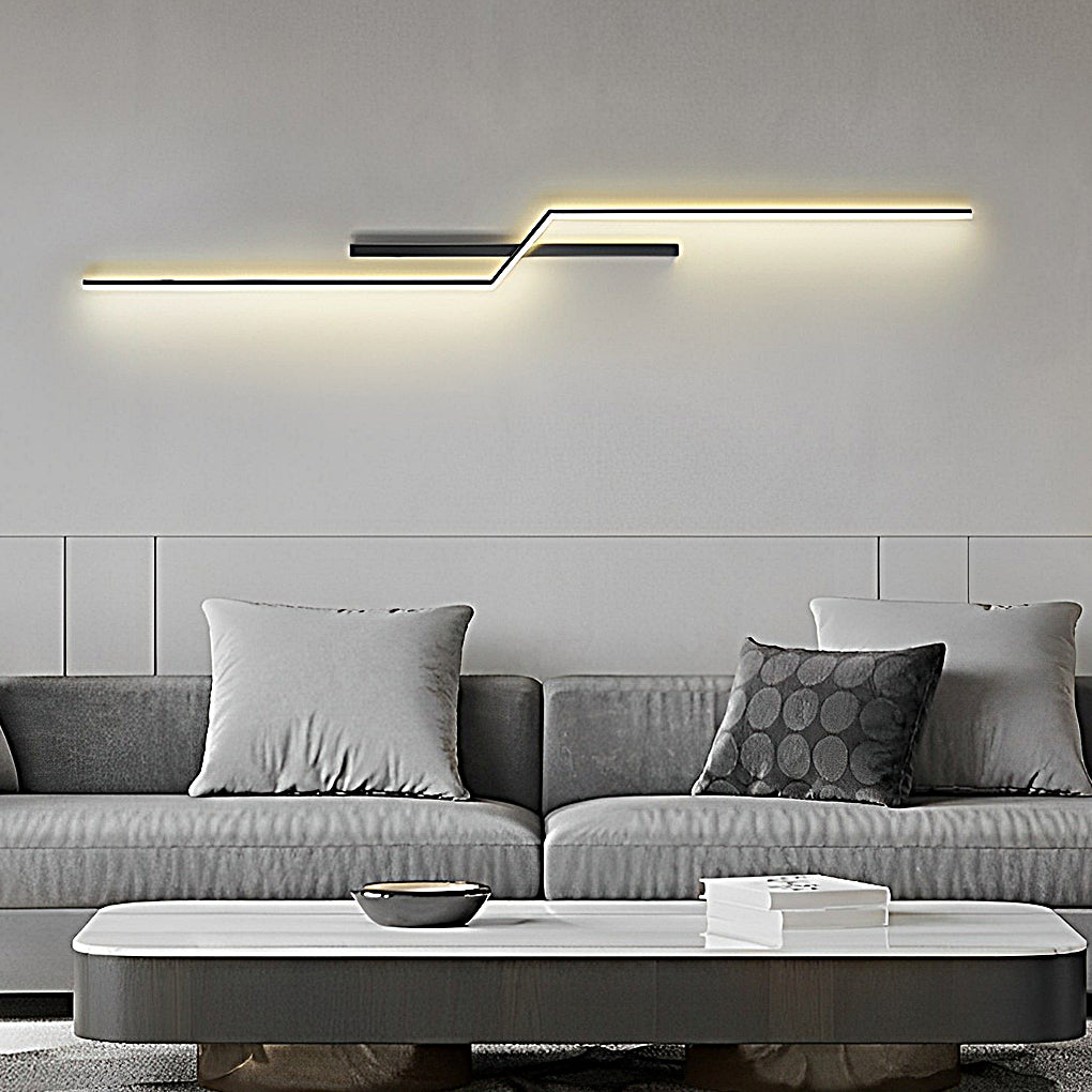 Horizontal modern linear wall sconce installed above sofa creating soft ambient lighting in modern interior.