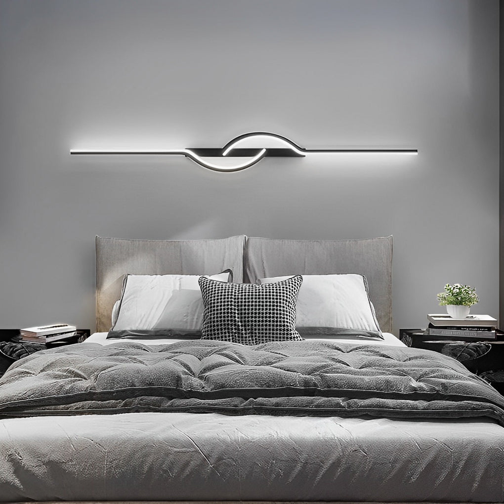 Close-up of modern linear wall sconce showing curved LED light detail.