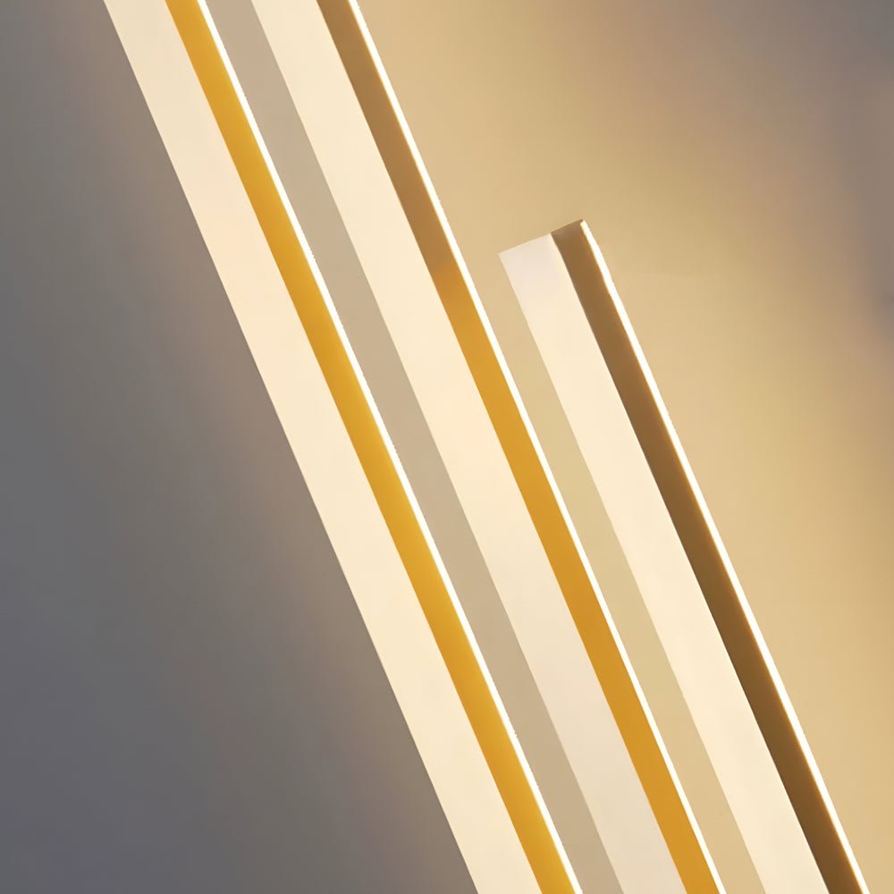 Modern linear wall sconce with a minimalist design and warm gold accents, ideal for contemporary interior spaces.