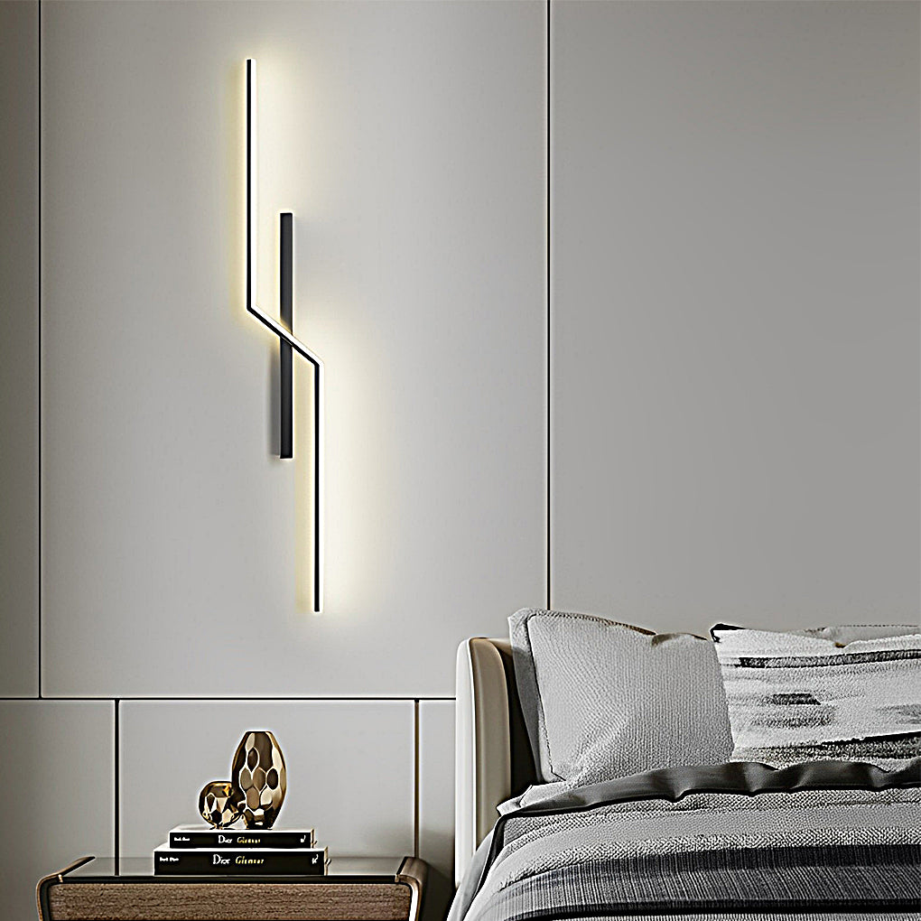 Slim modern linear wall sconce used as vertical decorative lighting beside bed in modern bedroom.