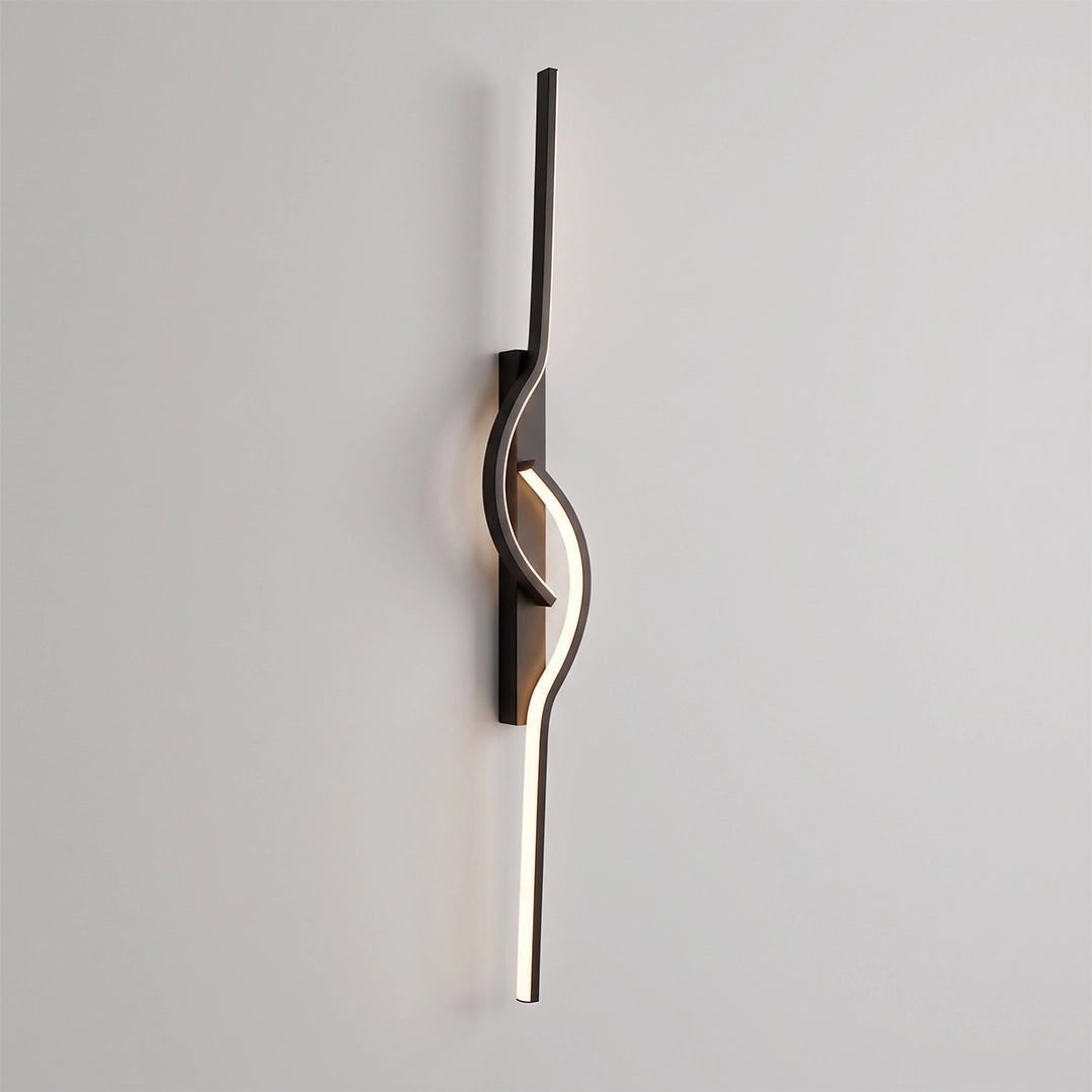 Modern linear wall sconce with a slim black frame and flowing wave-shaped LED light mounted vertically.