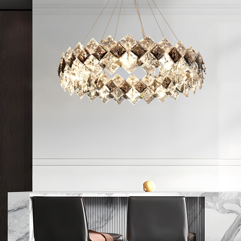 Modern luxury crystal room dining chandeliers illuminating a modern kitchen island with ambient light.