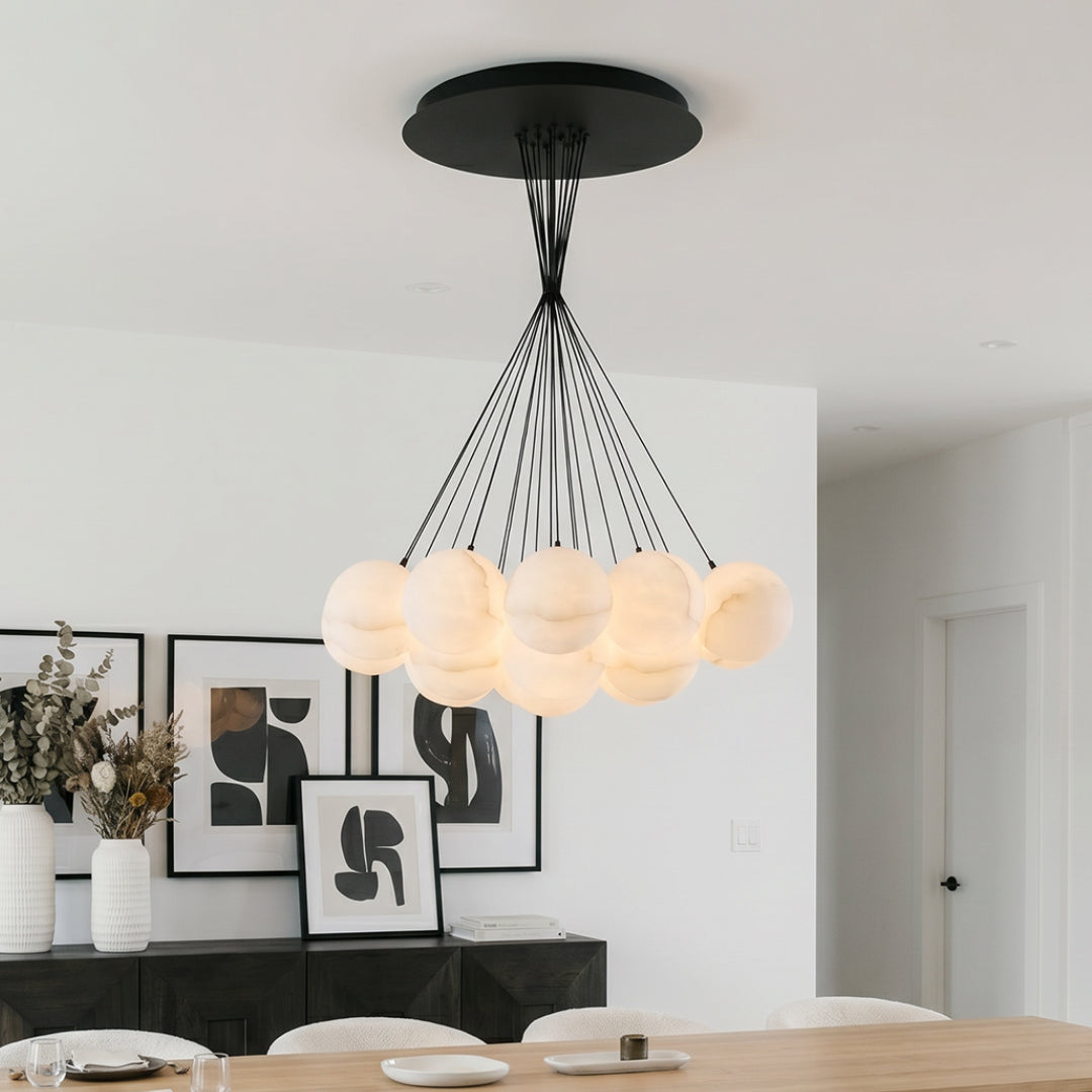 Modern matte black chandelier with clustered globe lights hanging in a bright contemporary dining area.