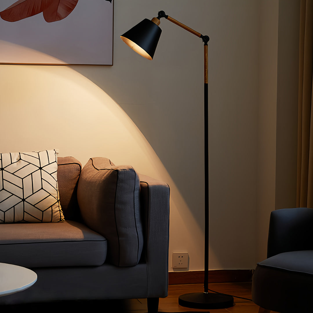 Modern metallic floor lamp with white cylindrical shade and brass finish in contemporary room setting