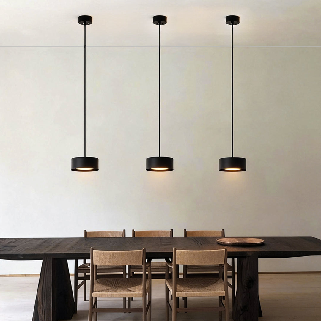 Modern mini pendant light fixtures illuminating a dining table with warm, ambient glow.