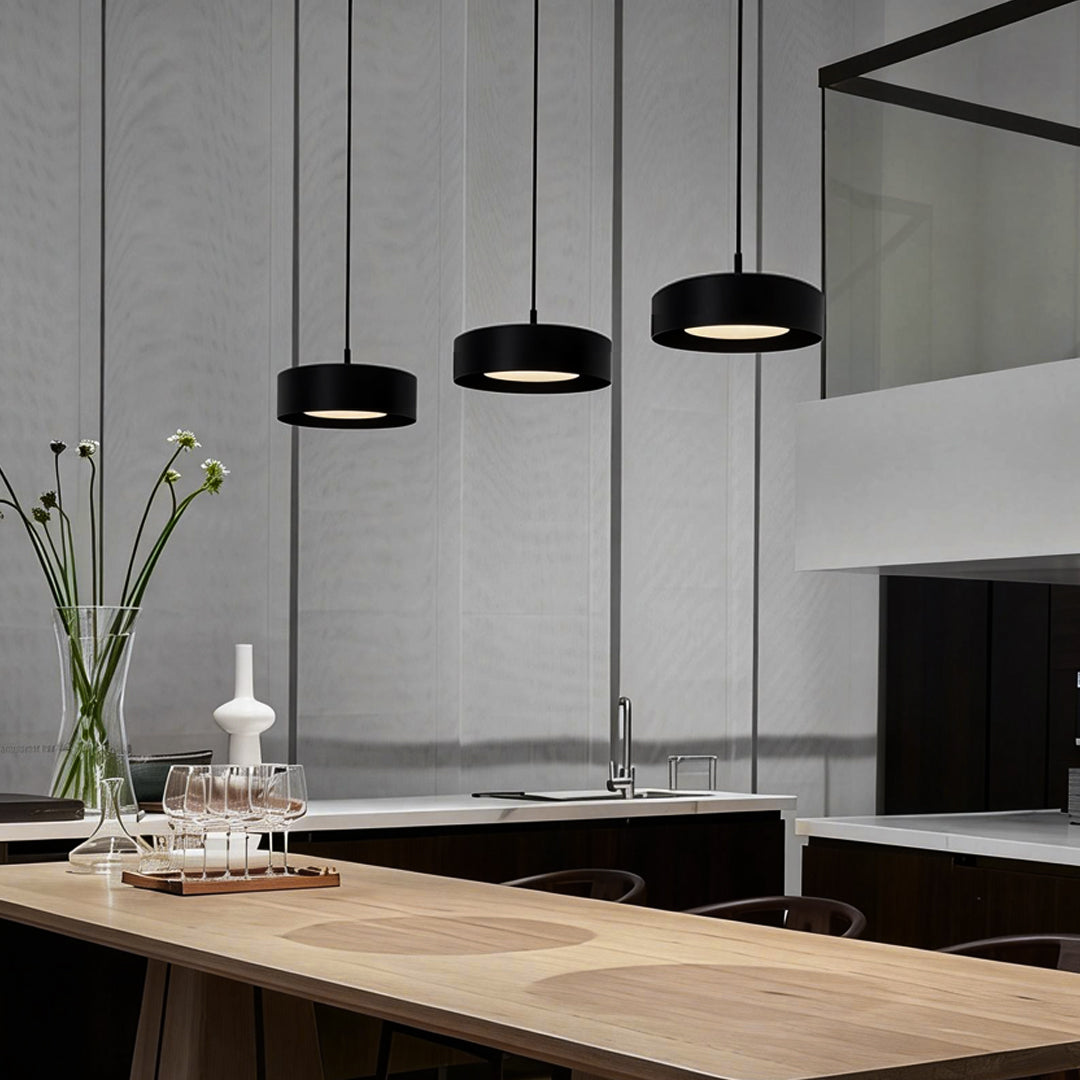 Modern mini pendant light fixtures providing soft illumination above a kitchen island.