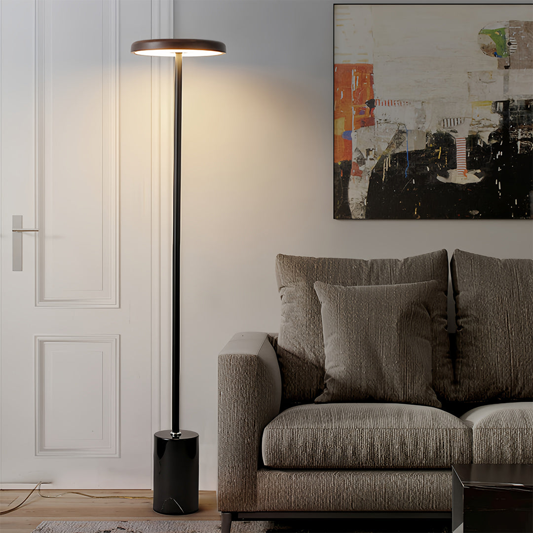 Modern minimalist floor lamp beside beige sectional providing clean lines and functional lighting design