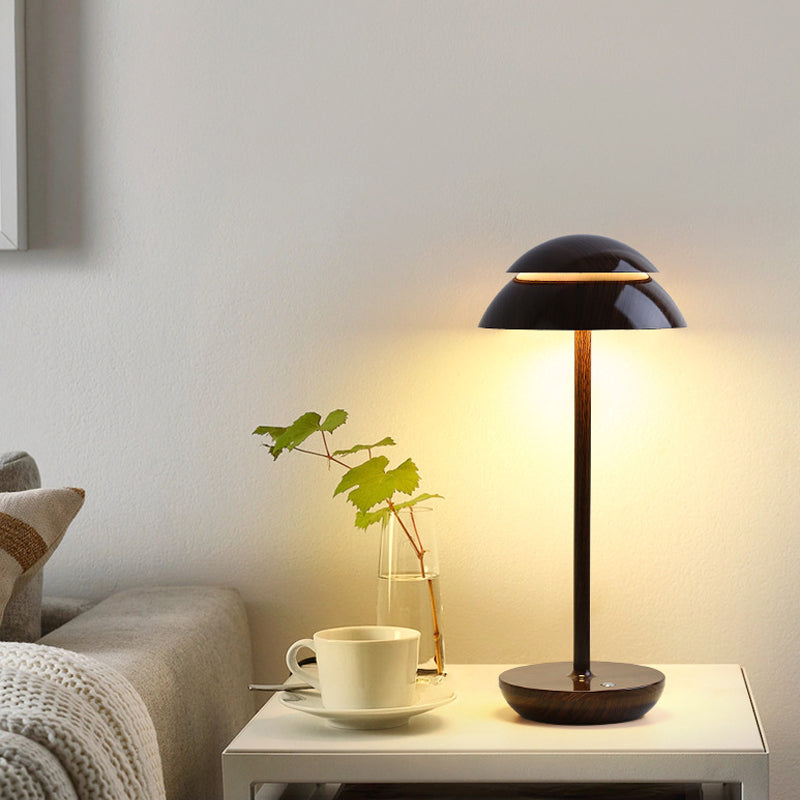 Modern mushroom table lamp with a close-up of the illuminated mushroom-shaped head.