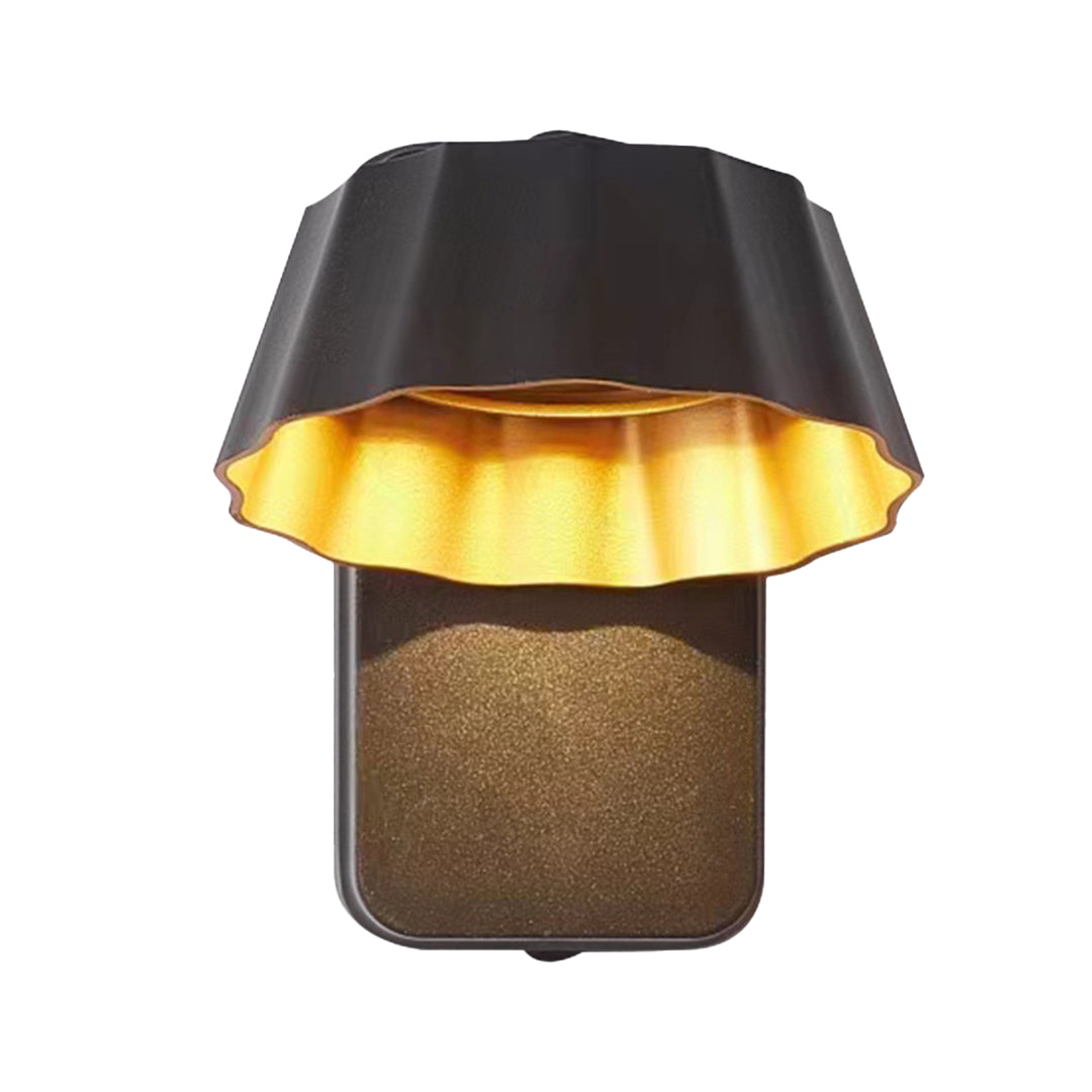 Modern mushroom-shaped wall sconce with black shade and golden interior creating warm downward lighting