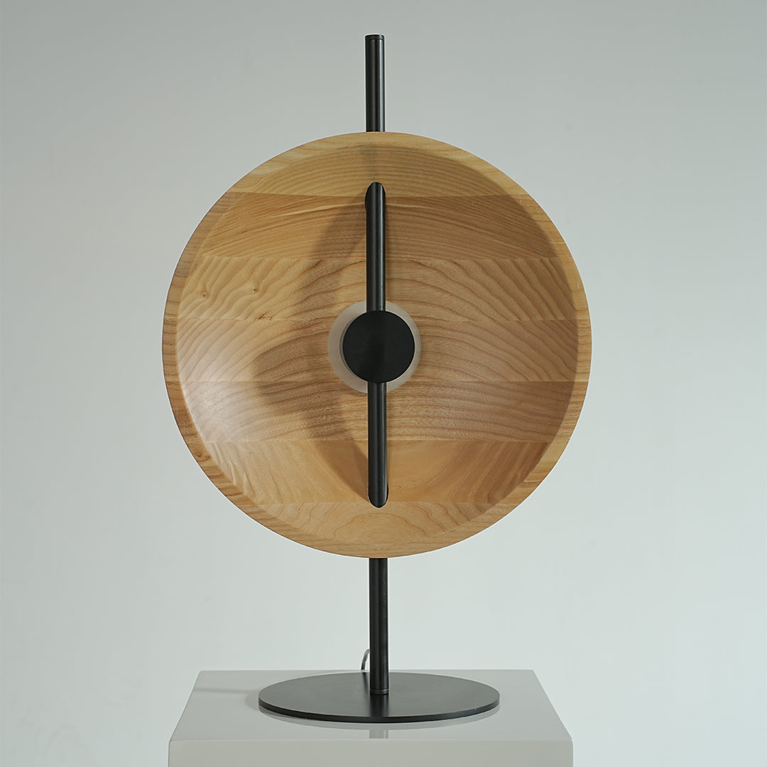 Natural wood modern table lamp with glowing ring center and minimalist form.