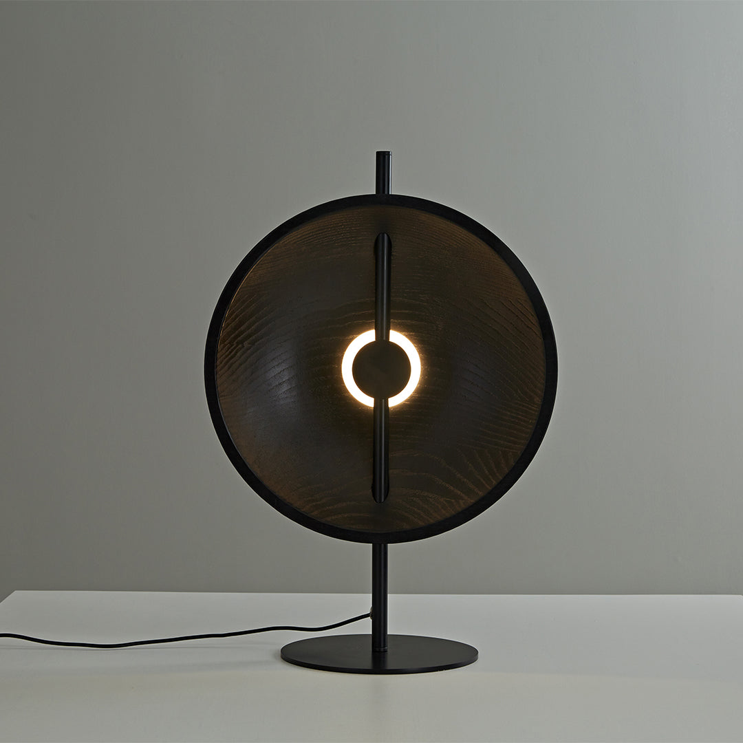 Natural wood modern table lamp with glowing ring center and minimalist form.