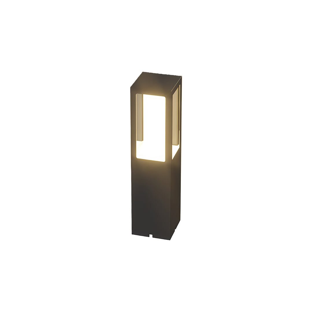 Modern outdoor bollard light with a sleek black rectangular design and warm light, perfect for garden pathways.