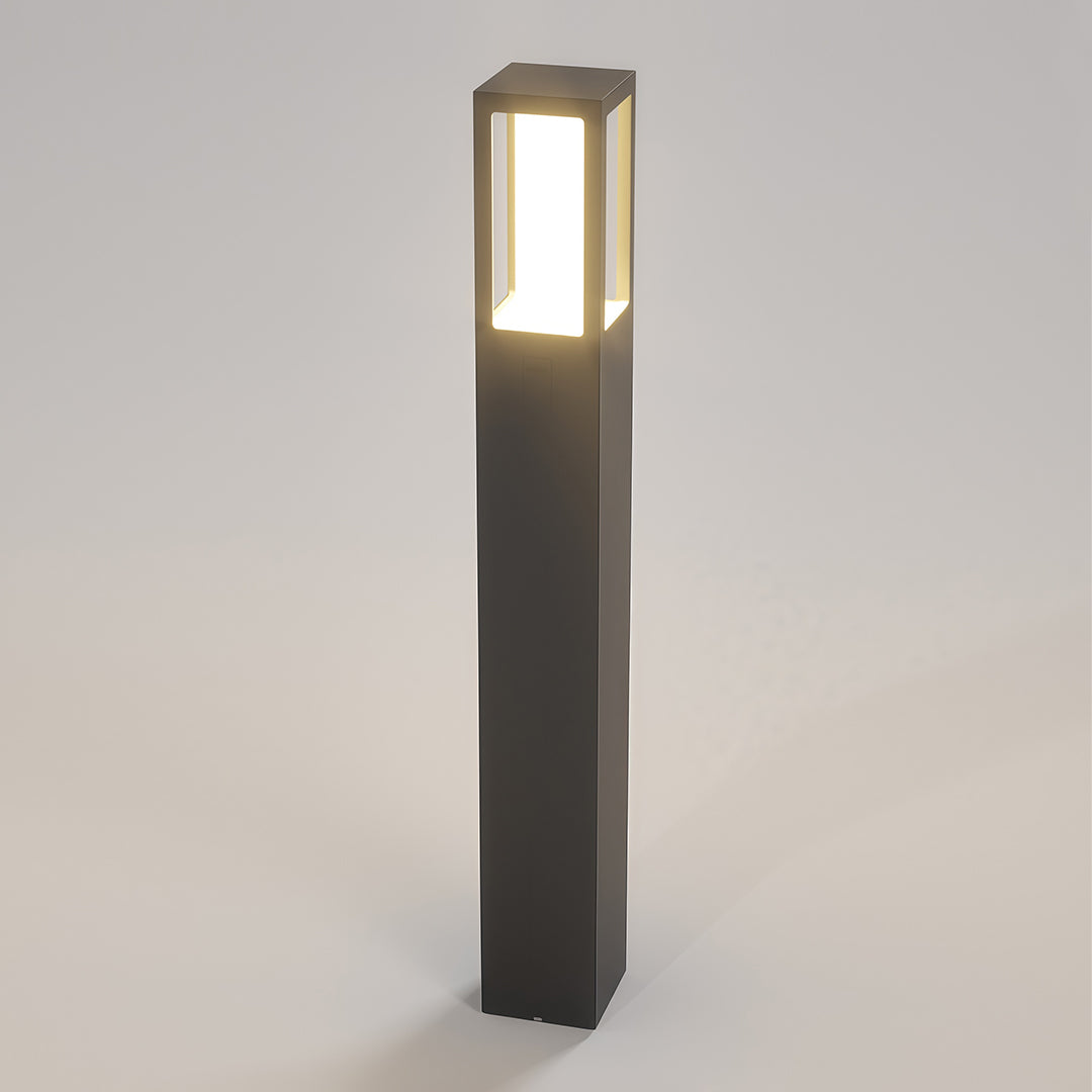 Modern outdoor bollard light with a tall black rectangular design, ideal for landscape lighting.
