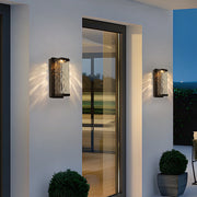 Modern outdoor wall light installed on contemporary building with evening illumination