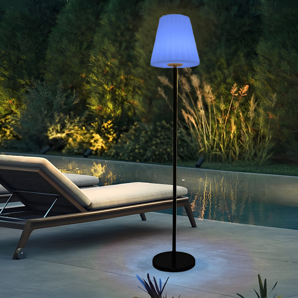 Modern outdoor floor lamps with a blue shade, adding a contemporary touch to a poolside lounge area.