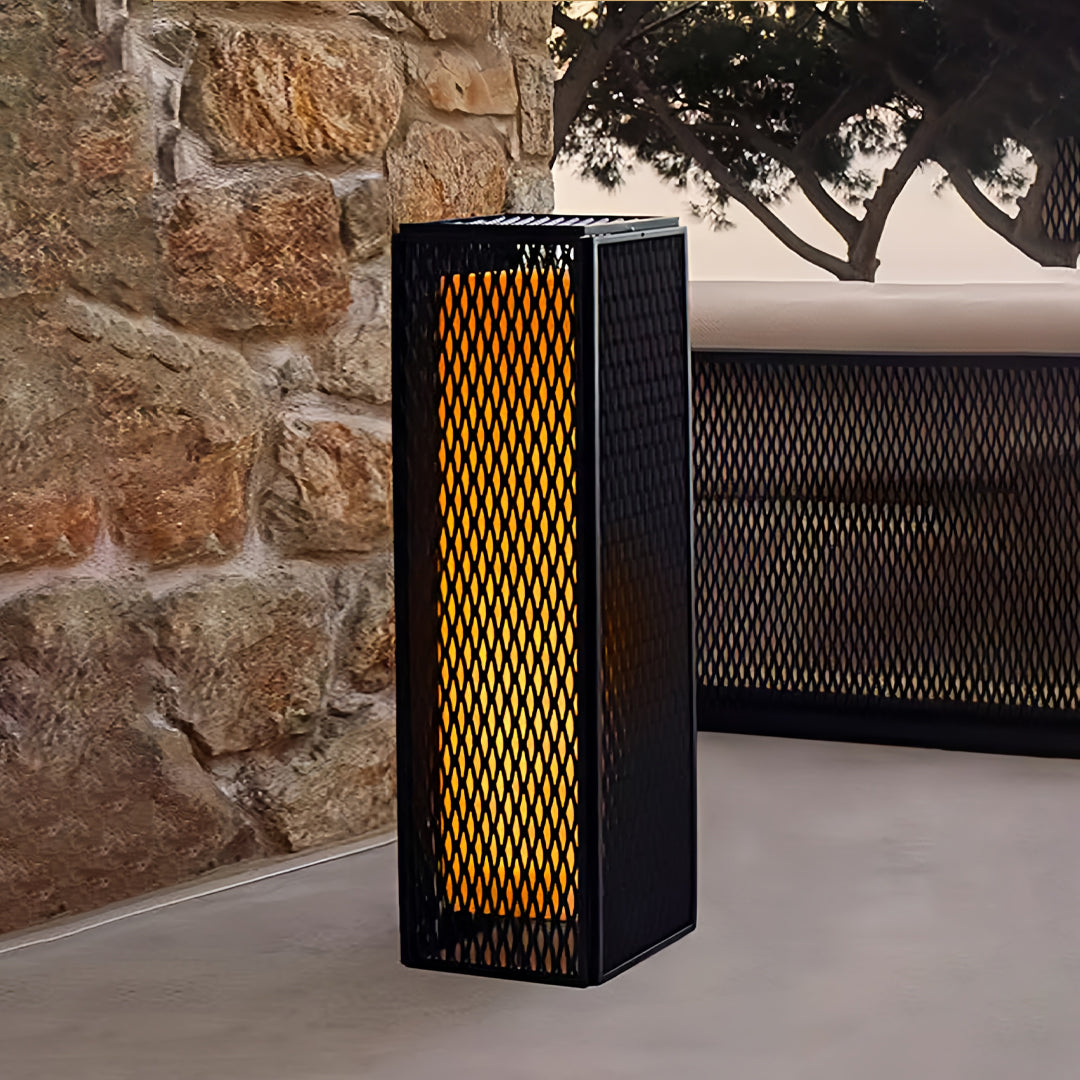 Modern outdoor lanterns showcased in a winter garden setting with snow-covered plants.