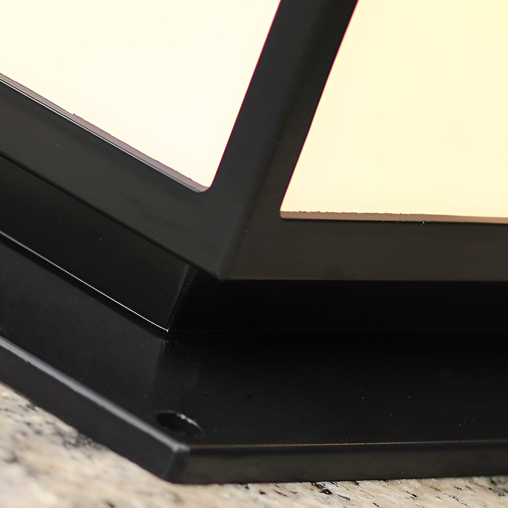 Modern outdoor pillar light with a minimalist black frame and frosted glass, installed on a concrete pillar for outdoor elegance.