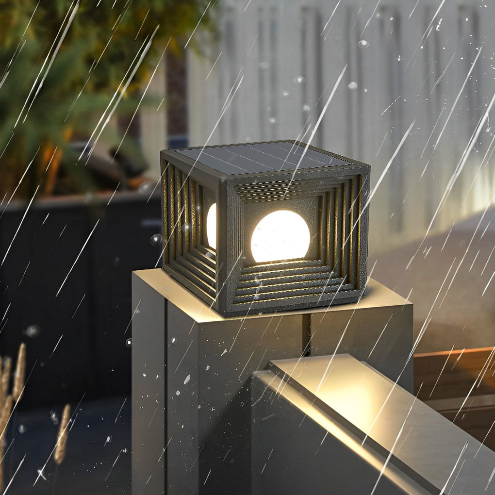 Modern outdoor pillar lights with a black finish, providing ambient light along a driveway.